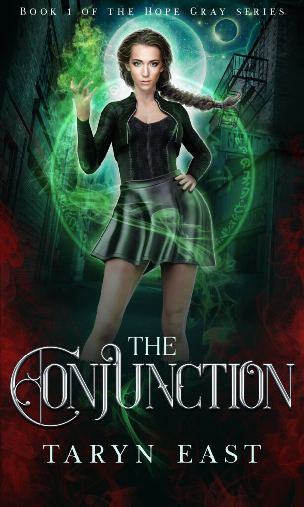 Woman with green eyes and swirling green magic stading in front of a dark alleyway. Below is the book title The Conjunction and author name Taryn East